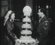 Het getrouwde stel naast een enorme taart